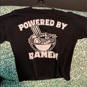 A T-shirt that says powered by ramen.